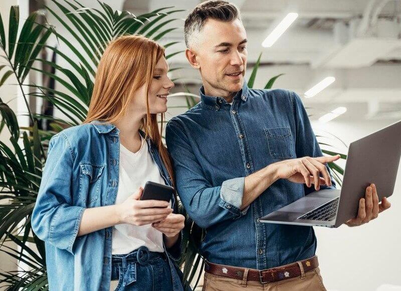 Man and woman looking at a laptop
