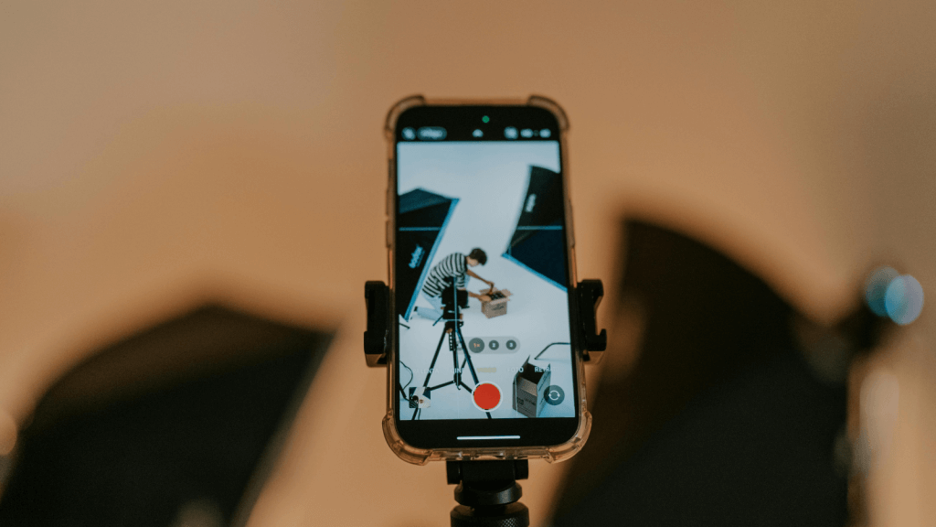 A man recording a video on his iPhone | Performance Creative Playbook: The 5 Ad Types Every Brand Needs to Test in 2025