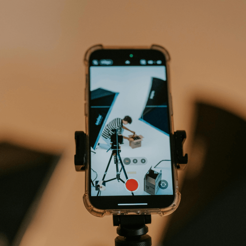 A man recording a video on his iPhone | Performance Creative Playbook: The 5 Ad Types Every Brand Needs to Test in 2025